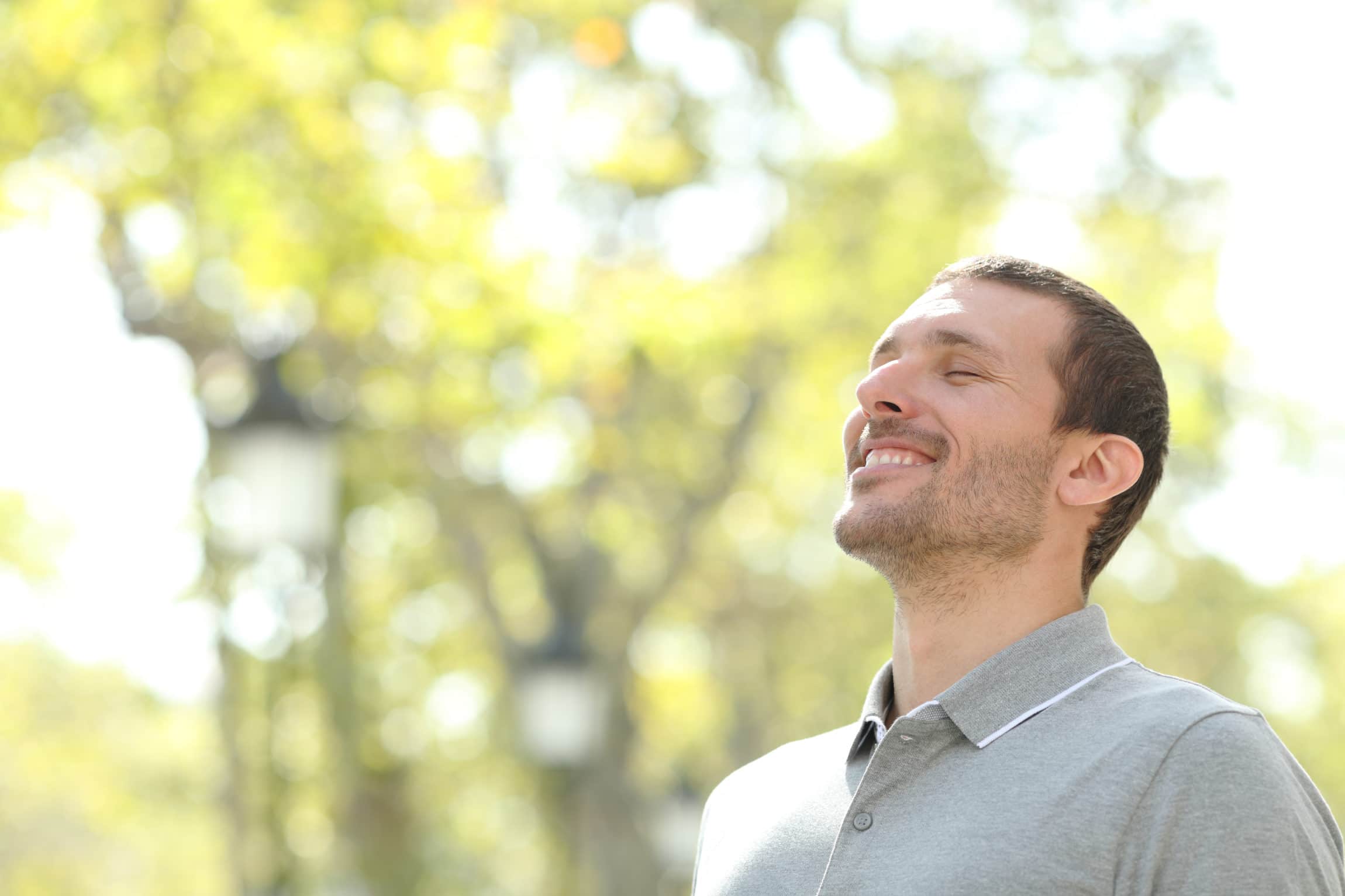 happy man breathing through nose in park