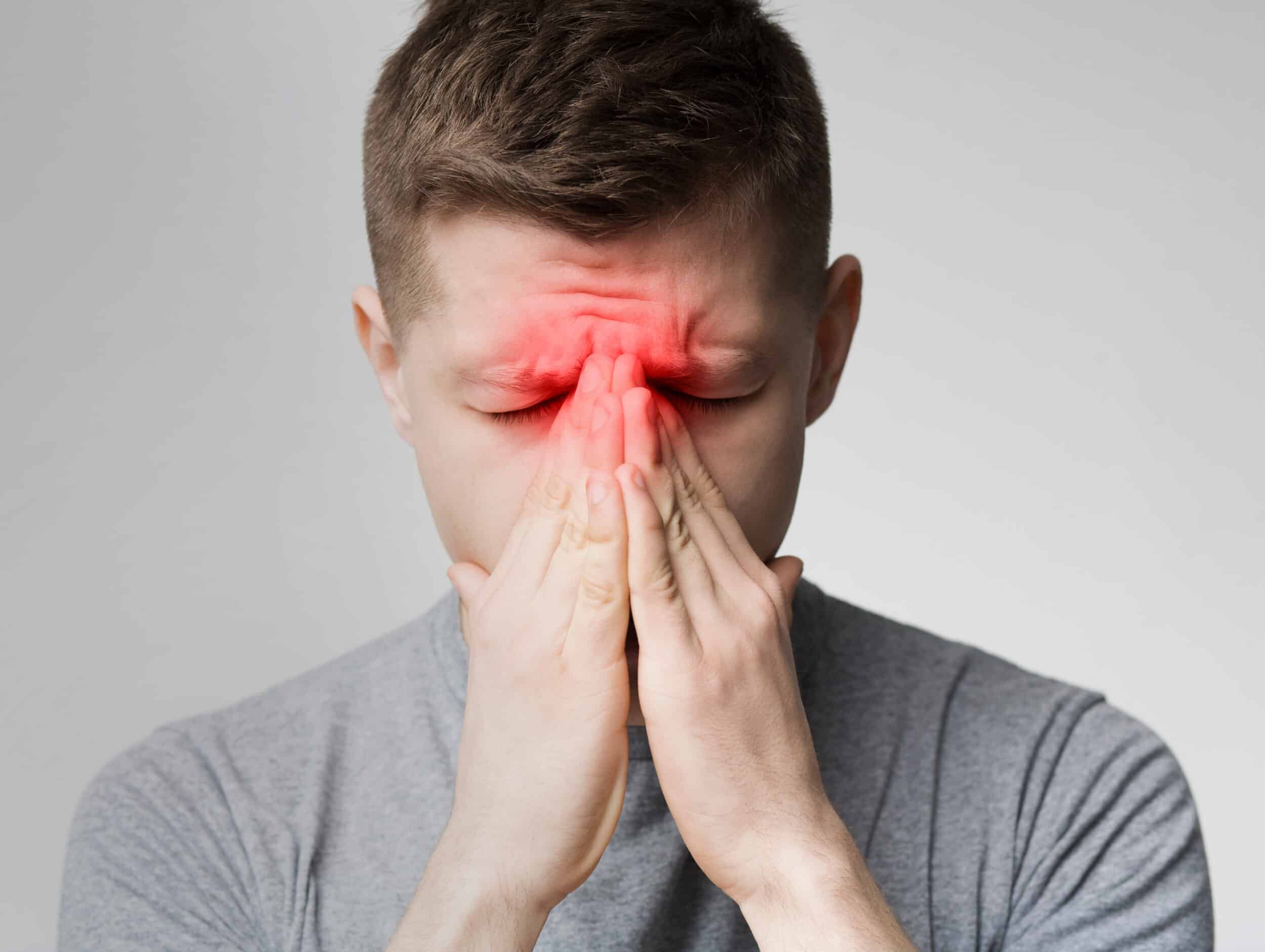 Frustrated,Young,Man,Suffering,From,Sinus,Pressure,,Touching,His,Nose