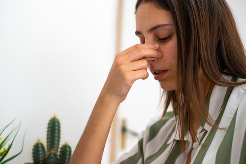 Woman with a nose pain.